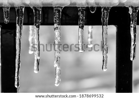 Mini icicles on a hand rail Royalty-Free Stock Photo #1878699532