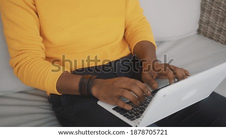 Close up, black man using laptop. Remote work or distance education concept. High quality photo
