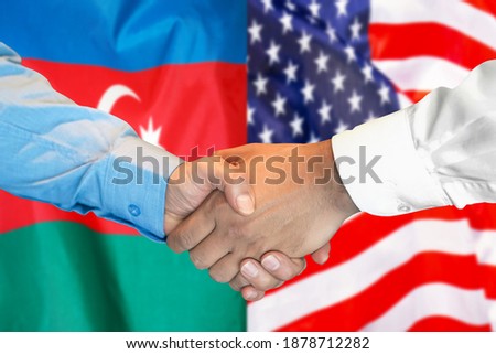 Business handshake on the background of two flags. Men handshake on the background of the Azerbaijan and US flag. Support concept.