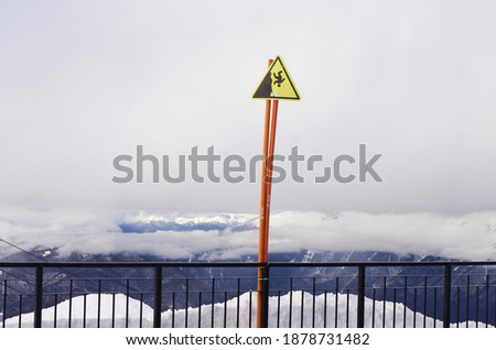 panoramic view of the winter mountain landscape. warning sign danger of falling down