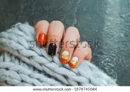 Women's hands with colorful pattern on the nails. 2020 colors trend. Top view. Place for text. Cozy winter design.