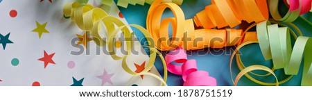 party background with colorful streamers for celebrating birthday. space with scattered confetti. Colorful celebration concept.