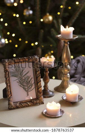 Decorative foto frame and burning candles, Christmas decoration