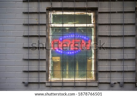 Illuminated red open sign on shop window