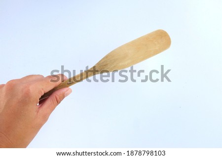 Picture of woman hand holding  Wooden Kitchen Spatula Kitchen Utensil For Cooking