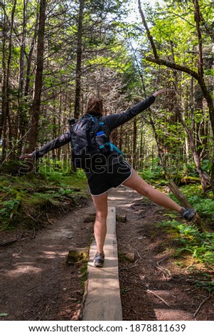 Woman Balances on Wooden Planks  On Dirt Trail