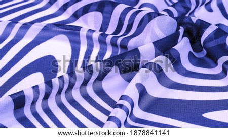 silk fabric, blue and white abstract lines. The magical shape of an abstract blue and white pattern. Retro modern decor, textile art, design, texture, background, pattern