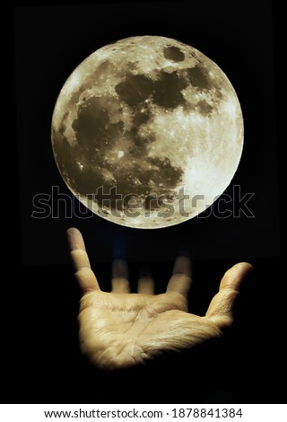 Abstract art with full moon over hand