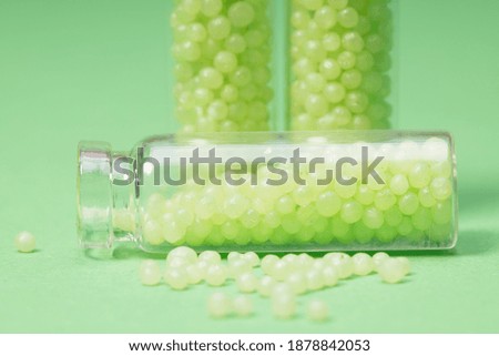 glass bottles with green granules on a green background