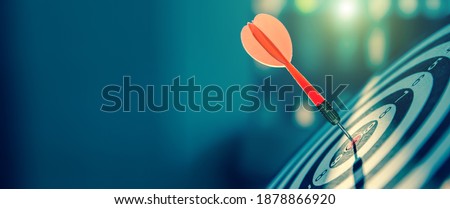 bullseye target or dart board has red dart arrow throw hitting the center of a shooting for business targeting and winning goals business concepts. Royalty-Free Stock Photo #1878866920