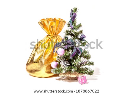 Sack of gold color filled to the brim with Christmas gifts. Isolated on a white background