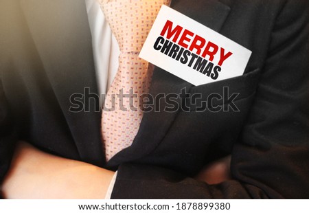 Merry Christmas card is held by businessman. Happy winter holidays. Business concept.