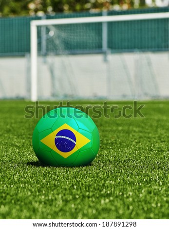 Soccer Ball with Brazilian Flag on the grass in stadium