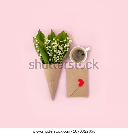 Bouquet of flowers and cup of coffee and mock up fpr letter message on pink, copy space, minimal greeting card for Saint Valentine, mom, woman day, birthday, romantic morning breakfast concept