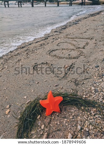 Happy New year 2021 concept. Text "2021" on the background of the beach at Adriatic seaside. With sea decorations like red star. Travelling in 2021 year.