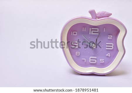 white and purple clock in white background