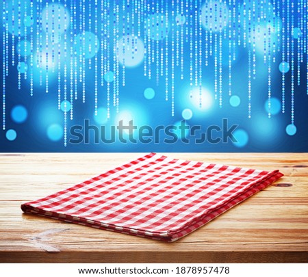 Red napkin on wooden table and Christmas background mockup.
