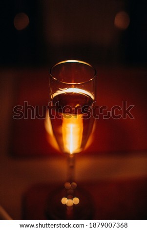 Glass of wine. Red background with light