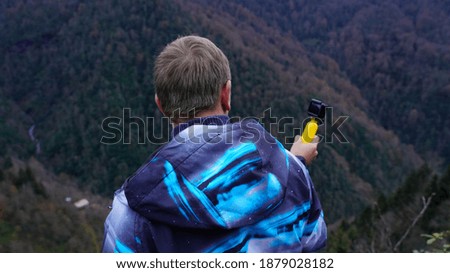 
A man with a camera photographing nature