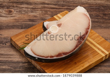 Raw shark steak served rosemary for cooking