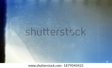 Blank grained toned film strip texture background with heavy grain and dust