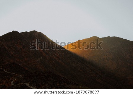 Sun rising on hills of Khor Fakkan  mountain hiking trails UAE
