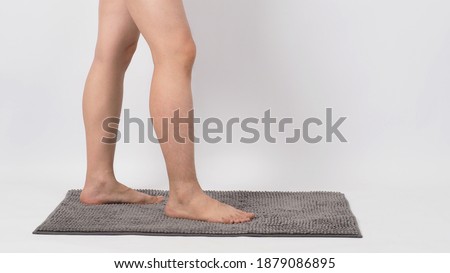 Legs of male barefoot standing on soft carpet. with white background.isolated and copy space