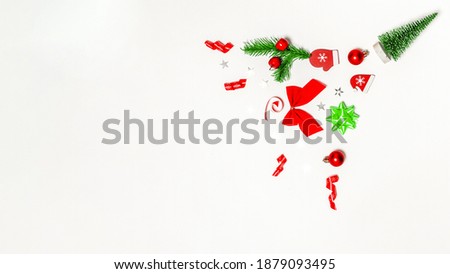 Xmas background white. Stocking, gifts, winter tree, ribbon and bow in Christmas composition on white background for greeting card. Flat lay, top view, copy space.