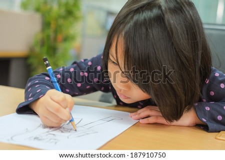 Cute little girl is drawing