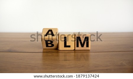 BLM vs ALM symbol. Turned cubes and changed word 'BLM - black lives matters' to 'ALM - all lives matters'. Beautiful white background. Business and BLM vs ALM concept. Copy space.