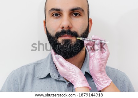 Cosmetic procedure for lip augmentation and wrinkle removal for a bearded man. Cosmetology