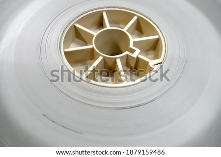 Close up a 35 mm film tape leader white color clear for film productions processing.