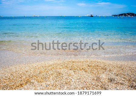 Beautiful summer seascape with ships, clear azure water and sandy beach in sunny day. High quality photo