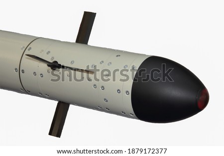 A close up view of black missile head with wings isolated on black.