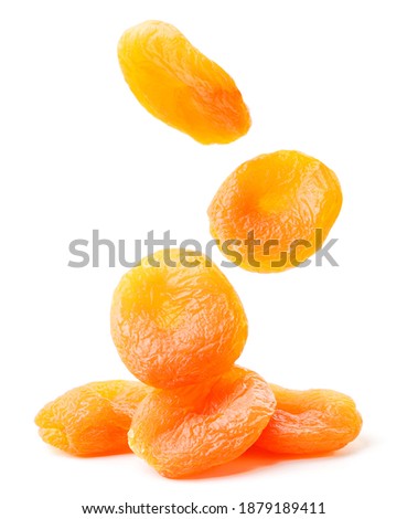 Dried apricots fall on a bunch on a white background. Isolated Royalty-Free Stock Photo #1879189411