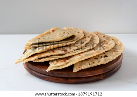 Gozleme or kutabs with herbs and cheese. Or the Dagestani dish chudu - stuffed flat cakes fried in a dry pan. Royalty-Free Stock Photo #1879191712