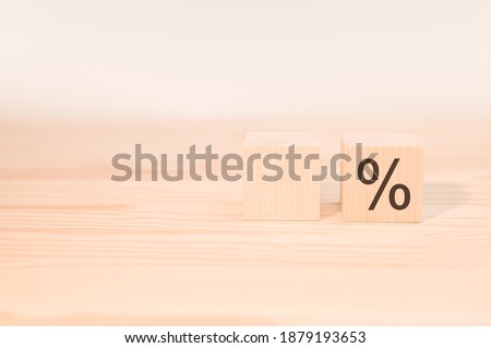 wooden dice cubes with percent symbol. one with space for your text, one cube with the percent sign. Concept of sale and discount. Close up a percentage sign with empty wood cube for text number