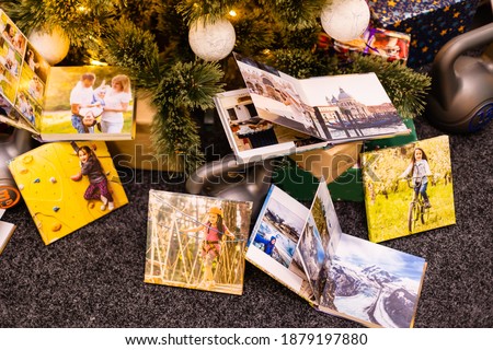 photobook, album and weights for sports near the Christmas tree as a gift holiday
