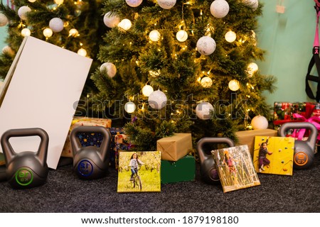 Square canvas and weights for sports as a gift. Christmas and New Year concept.