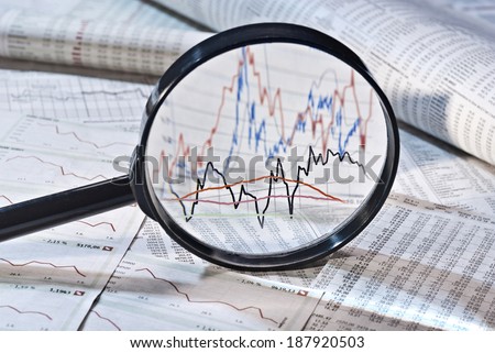 Magnifier shows the variation of stock prices, Royalty-Free Stock Photo #187920503