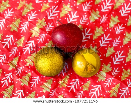 Photo christmas background with balls and an apple on bright colored paper. Example of a Christmas and New Year background for a design