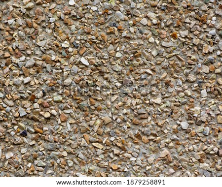 Wall with crushed stone facade. Stone background