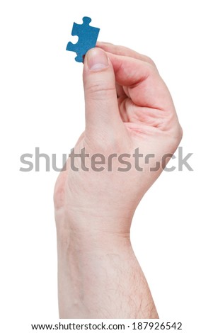 male arm holding jigsaw puzzle piece isolated on white background