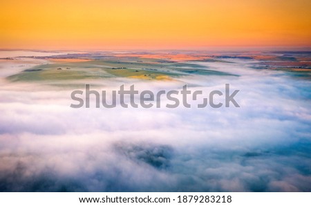 Agricultural lands are covered with thick fog in the morning. Location place Dniester canyon of Ukraine, Europe. Aerial photography, drone shot. Vibrant photo wallpaper. Discover the beauty of earth.