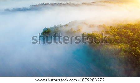 Peaceful misty view of the countryside with the rays of morning light. Location place Dniester canyon of Ukraine, Europe. Aerial photography, drone shot. Photo wallpaper. Discover the beauty of earth.