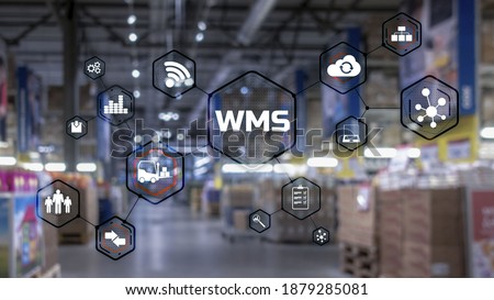 Inscription WMS on blurred warehouse background. Werehouse Management System. Royalty-Free Stock Photo #1879285081