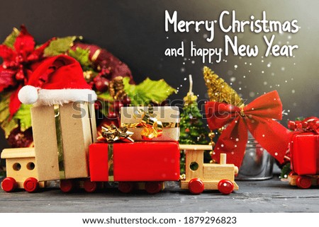 Merry Christmas and happy New Year card, toy train filled with christmas ornament and decoration