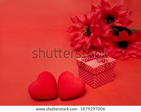 Gift box with a bow two hearts and red flowers. Festive concept for Valentine's Day, Mother's Day or Birthday.