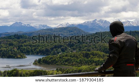 young motorbike driver from behind watching the landscape of bariloche
