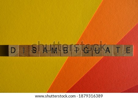 Disambiguate, word in wooden alphabet letters isolated on colourful background